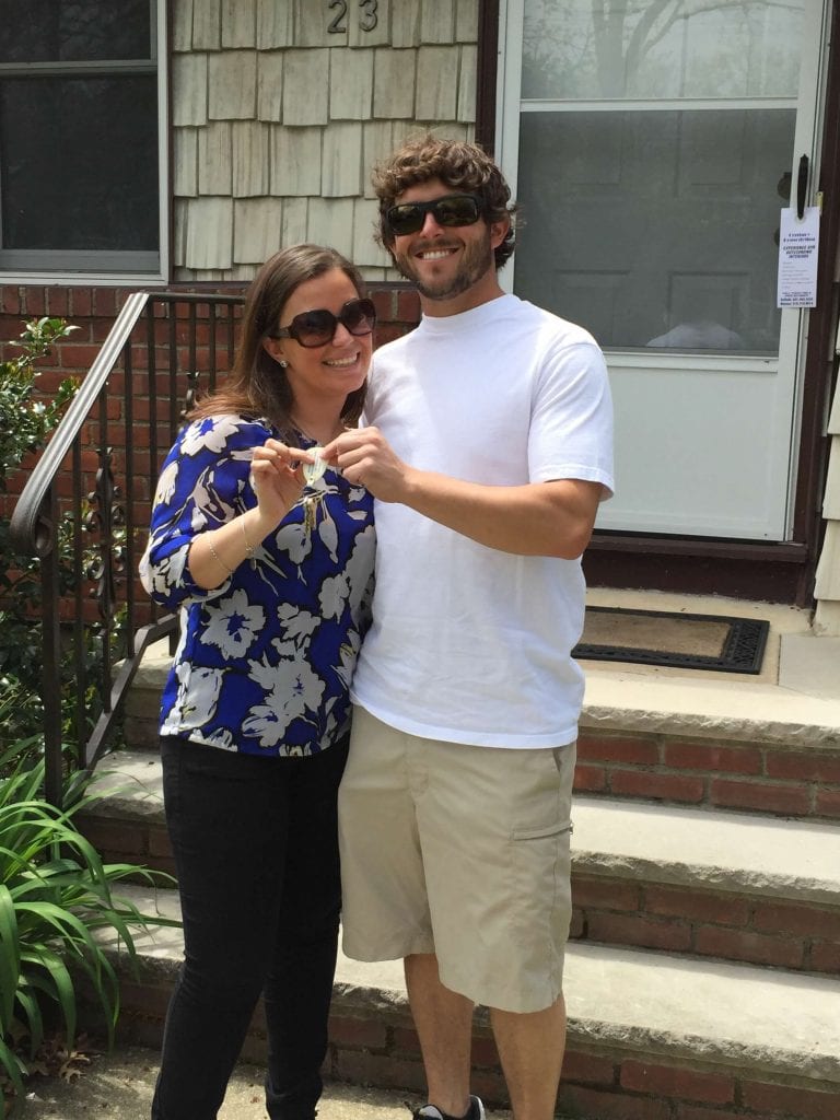 Couple in front of new home